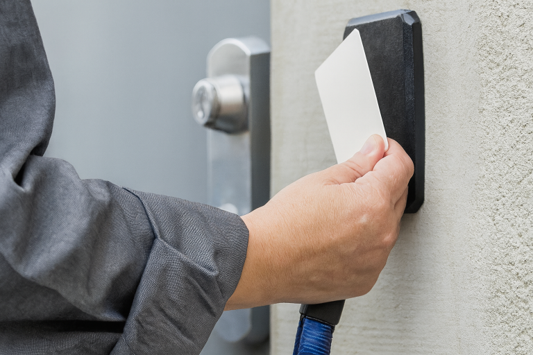 Range security personnel using a keycard to enter an indoor shooting range