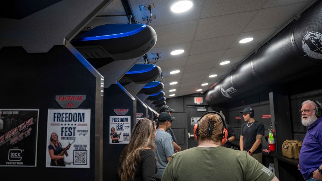 Shooters conversing in the staging area of a commercial indoor range