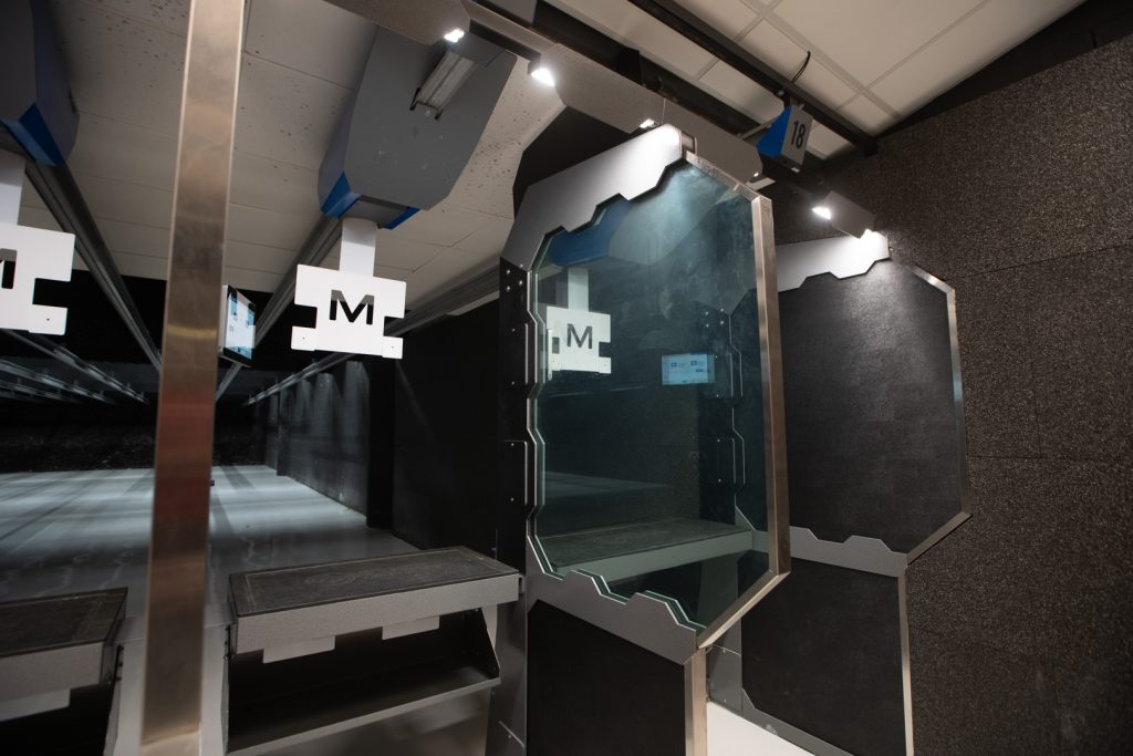 A brightly illuminated stall in a commercial indoor range