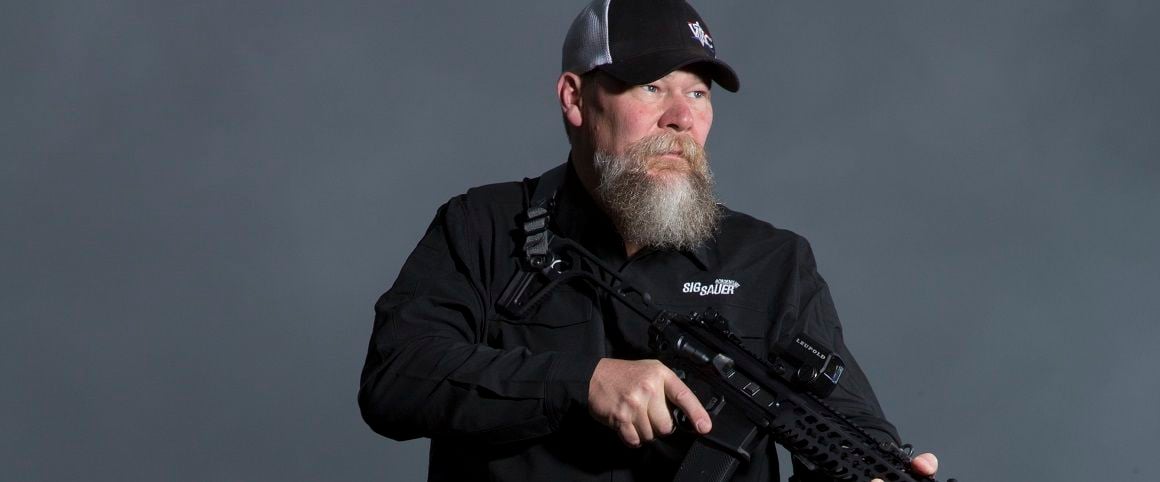 Representative from Viking Tactics holding a rifle.
