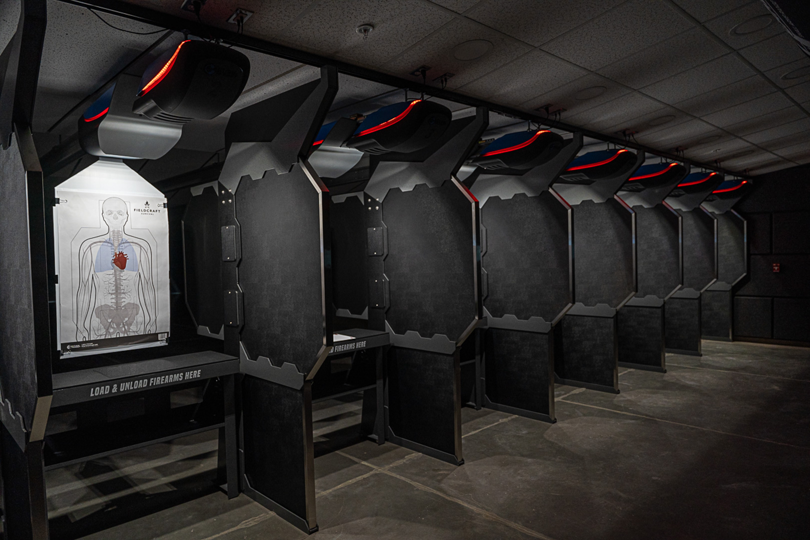 Defender stalls with textured ABS skin in a dimly lit range